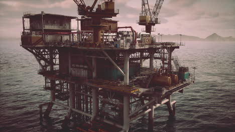 a large oil rig platform stands in the middle of the ocean.