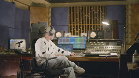 young caucasian man working at music recording studio