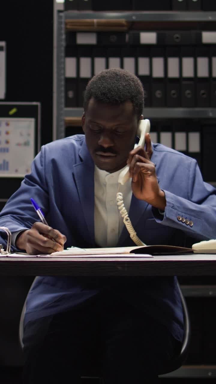 Man using phone at desk in office