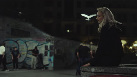 attractive girl walking city in casual clothes in urban buildings at night.