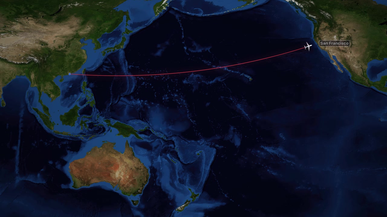 A red line tracks an airplane flying across the Pacific Ocean on a world map