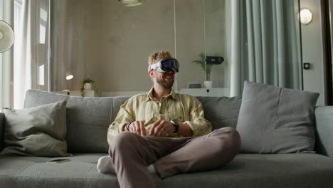 man using vr headset on a couch