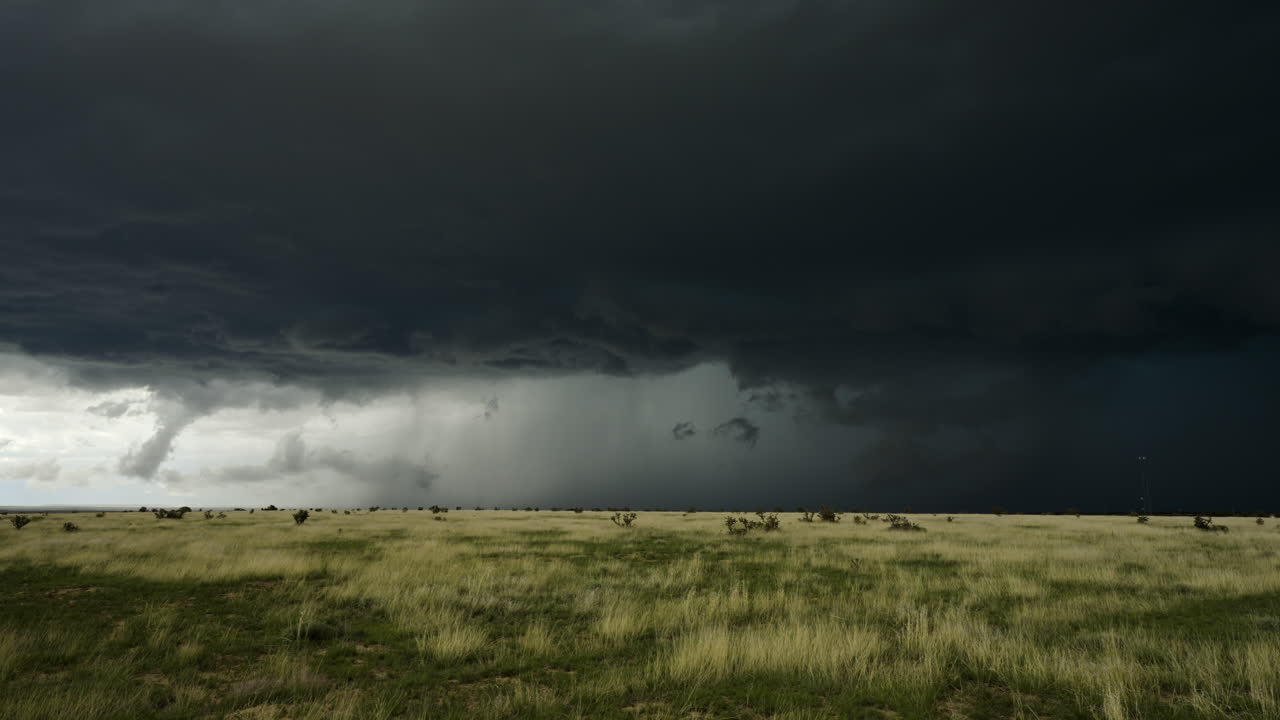 Threatening Storm Clouds Build Over Open Fields In Summer
