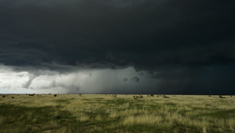threatening storm clouds build over open fields in summer