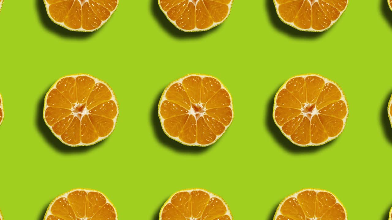 Pattern with mandarins in geometric grid on a green background. Minimal seamless motion graphics nature fruit animation