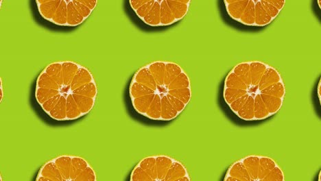 patrón con mandarinas en cuadrícula geométrica sobre un fondo verde. gráficos de movimiento sin costuras mínimos animación de frutas de la naturaleza