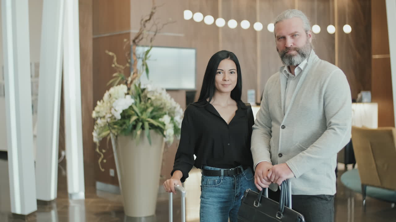 Couple with Luggage in Hotel Lobby