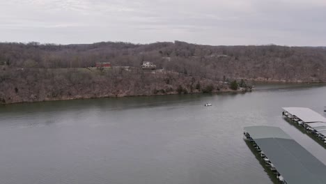 lone boat passing marina on lake