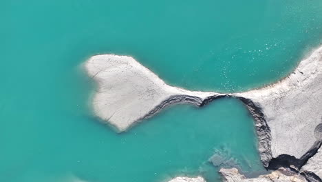 drone footage heart shaped blue green water transparency lake shore