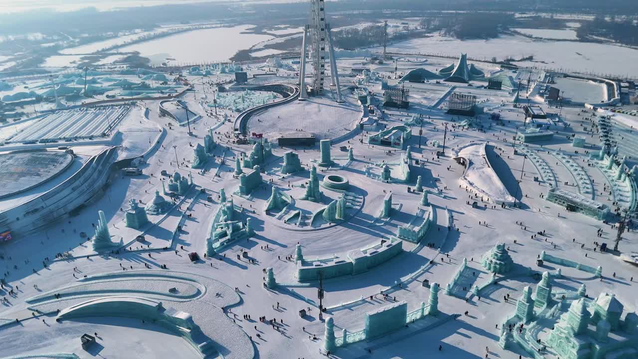Establishing drone shot of Harbin Ice Festival sculptures and ice block in the day in Harbin, Heilongjiang, China
