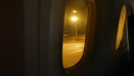 video from inside the plane through the windows of aircraft while taxiing on taxi way in the evening flight time