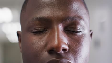 Video-close-up-portrait-of-the-opening-eyes-of-african-american-male-medical-worker