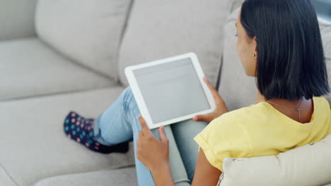 a-teenage-girl-using-a-tablet-on-the-sofa-at-home