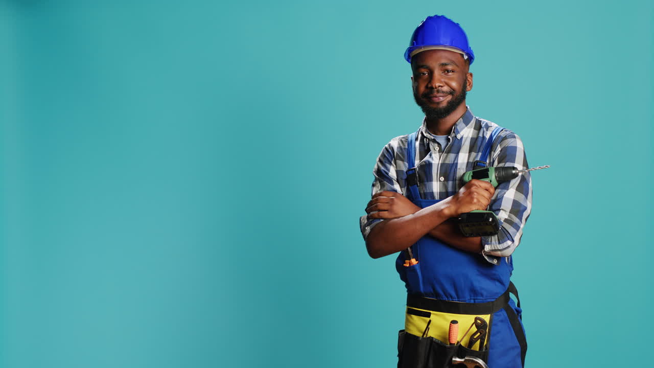 Construction worker posing with power drill gun