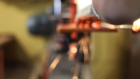 Blurry-view-of-metal-being-sanded-generating-beautiful-red-sparks-of-light-rays