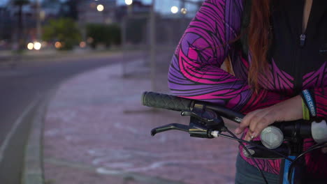 a girl waiting for her friends on her bike