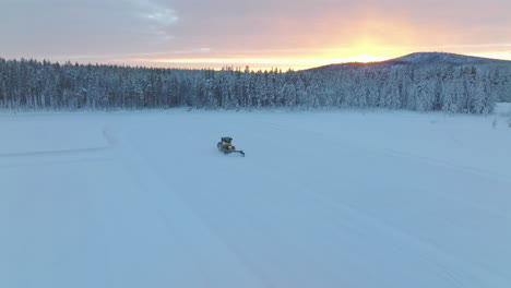 tractor emerging from lapland woodland preparing norbotten racetrack snow removal at sunrise