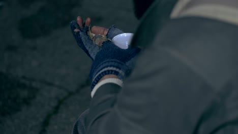 hands of homeless people  counting daily alms