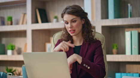 stressed employee videocall laptop conference closeup. serious woman discussing