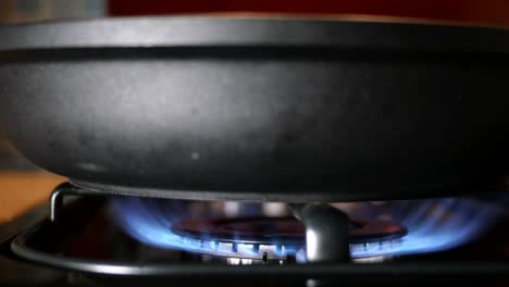 process of burning and appearing blue flame of gas methane or propane on kitchen gas stove.