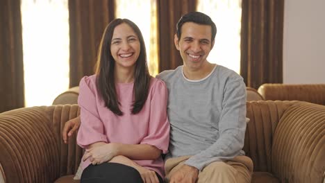 Happy-Indian-couple-laughing-towards-the-camera