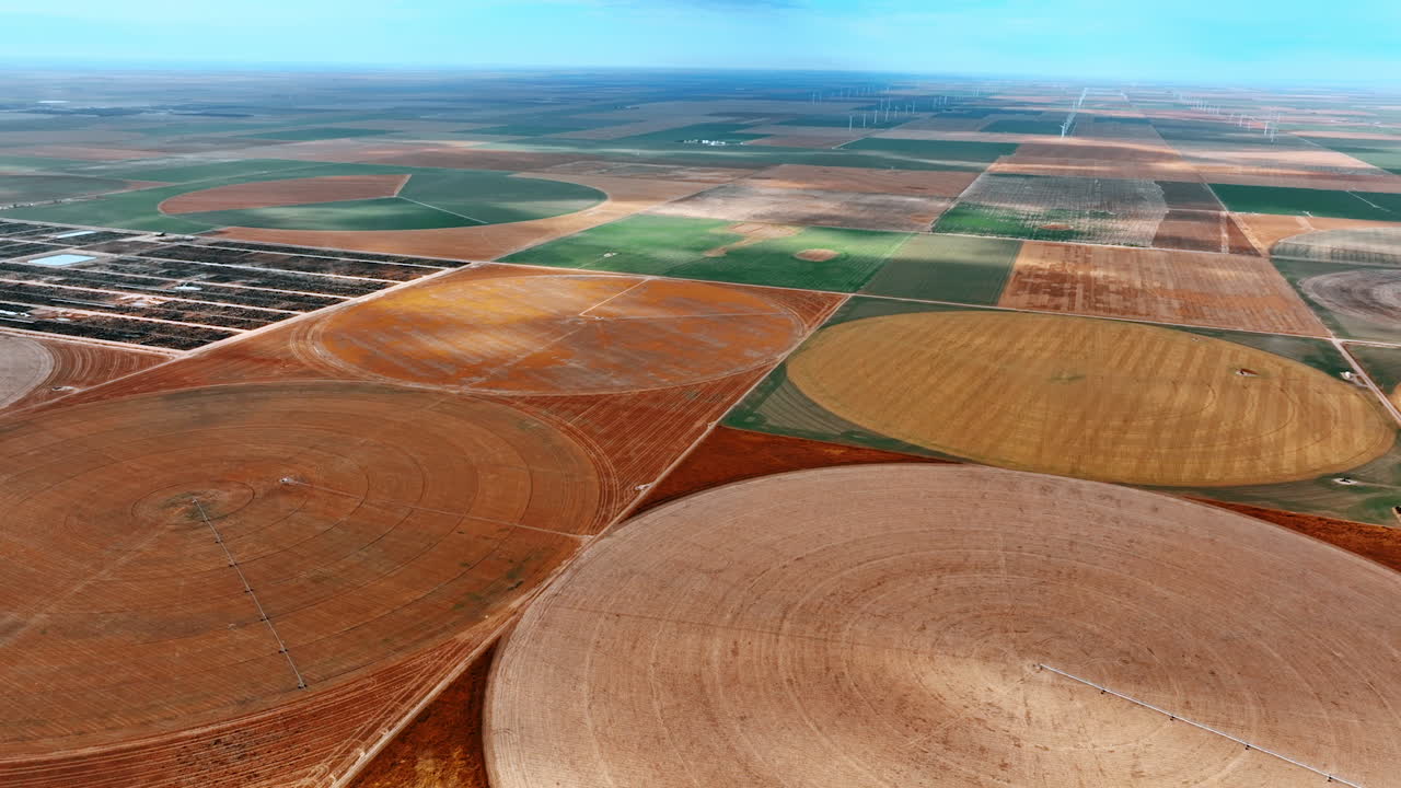 Amazing scenery of vast agricultural plantations divided into rectangular areas and circles. Top view on center-pivot-irrigation farms.