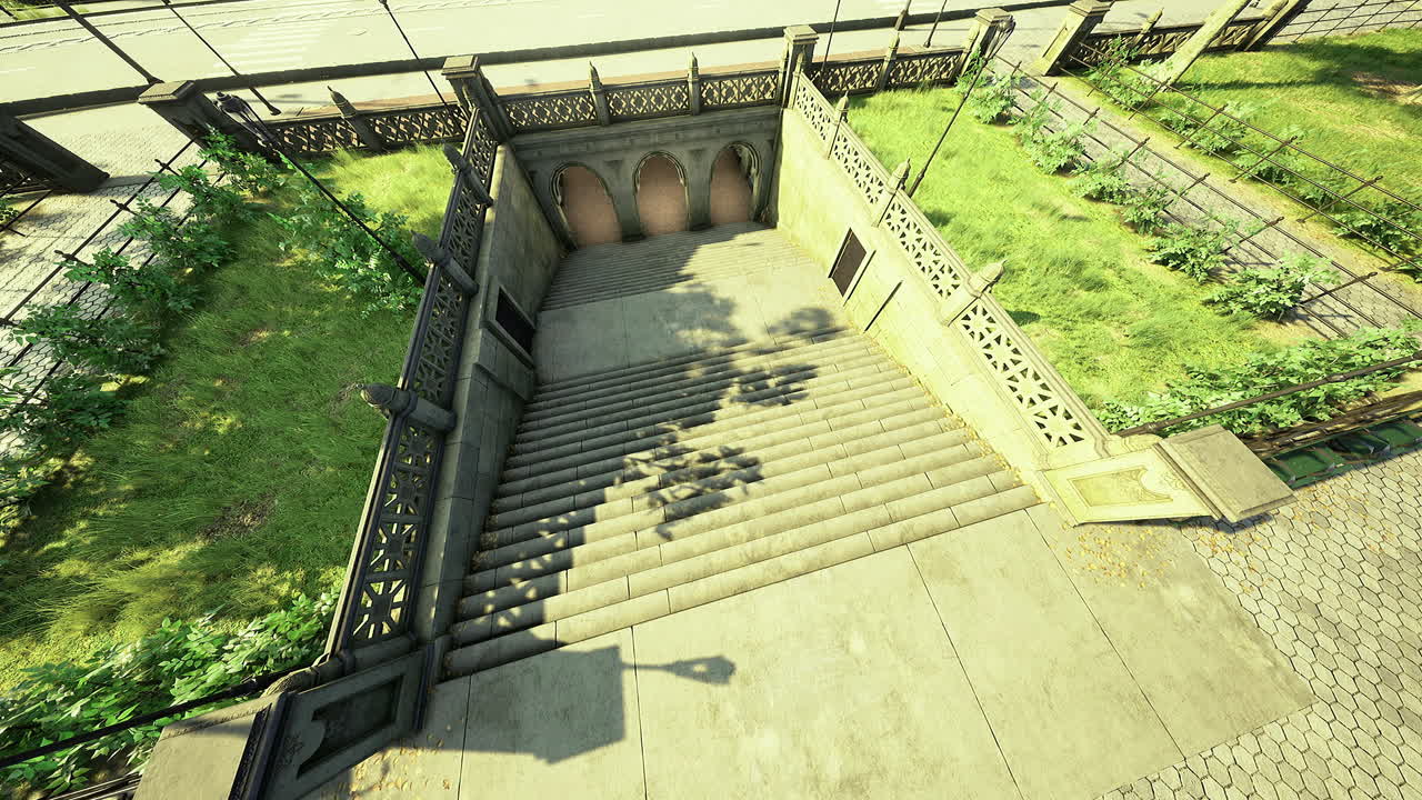 Steps leading to a park entrance in a city during daylight with greenery