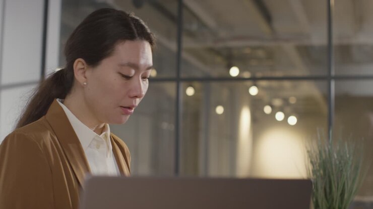 Businesswoman Interviewing Off Camera Candidate For Job In Office 1