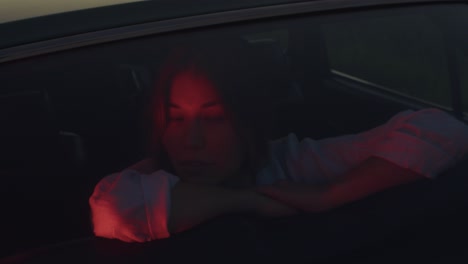 Woman in a car at sunset
