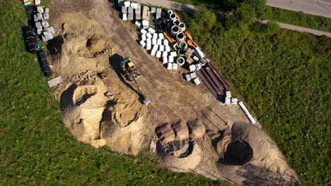 Luftaufnahme-Eines-Arbeitskrans,-Der-Bei-Sonnenuntergang-Sand-Auf-Der-Baustelle-Lädt