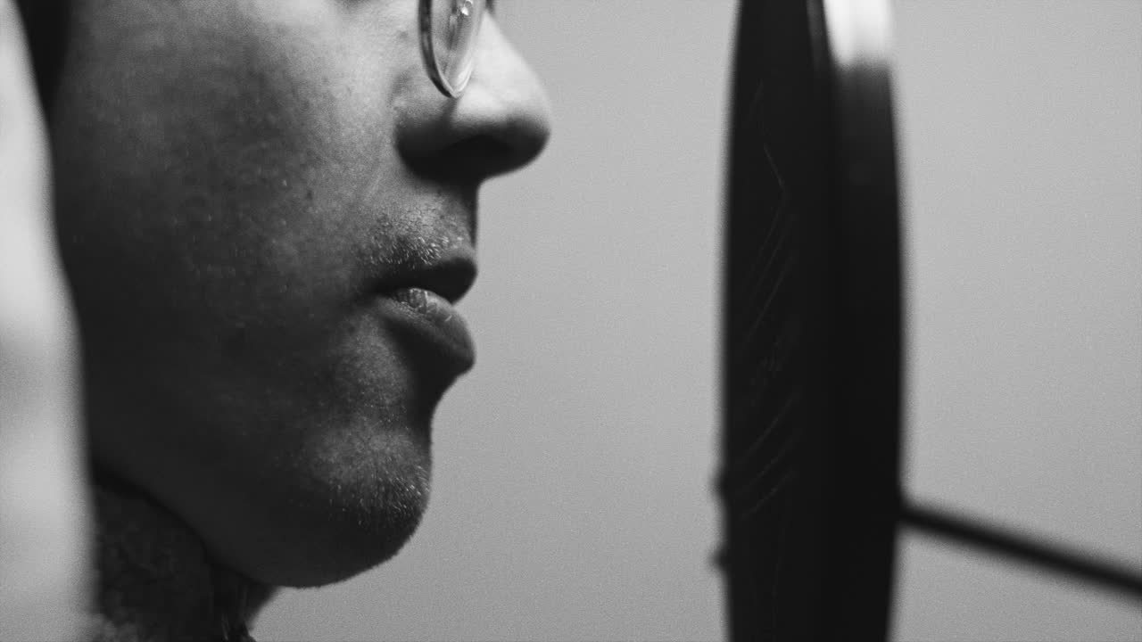 Person Singing into a Microphone in a Recording Studio