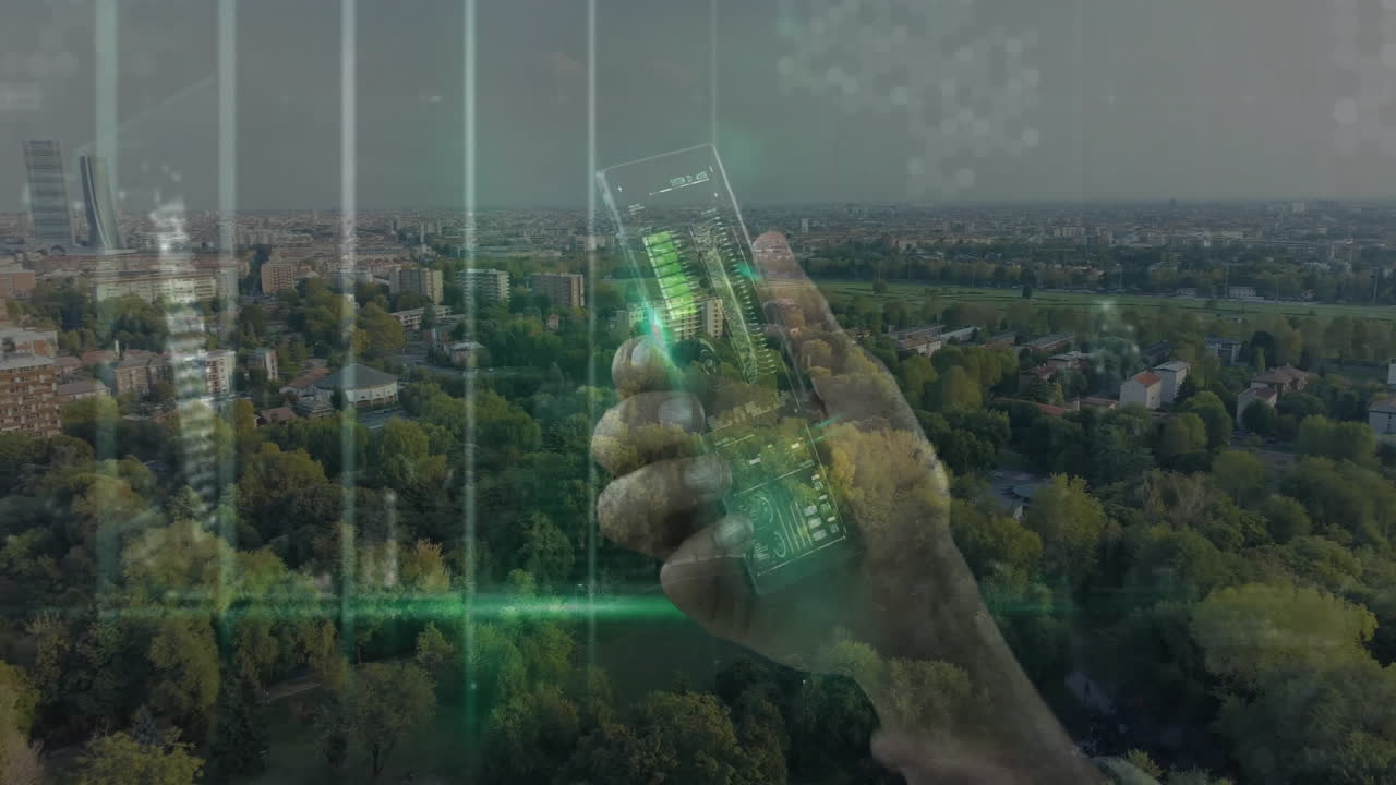 Holding smartphone with digital animation over cityscape and green park view