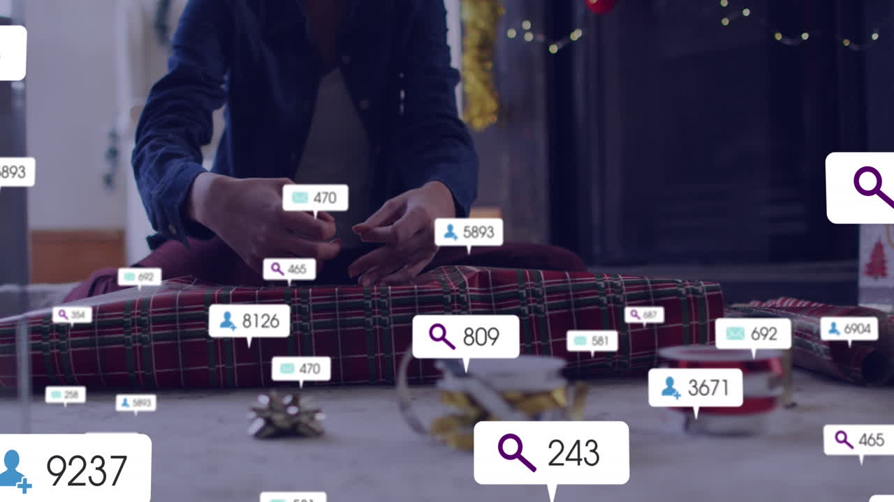 Animation of social media icons with numbers over caucasian woman packing presents