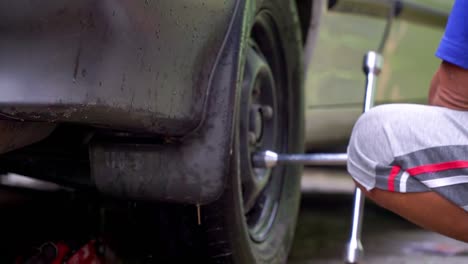 Close-up-shot-of-hand-man-use-wrench-to-to-loosen-the-nuts-of-car-rim---Replace-car-wheel-process