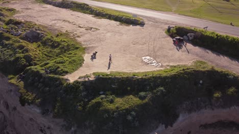 aerial orbit shot of tourist couple arriving epic cliffs of mar del plata during trip in argentina