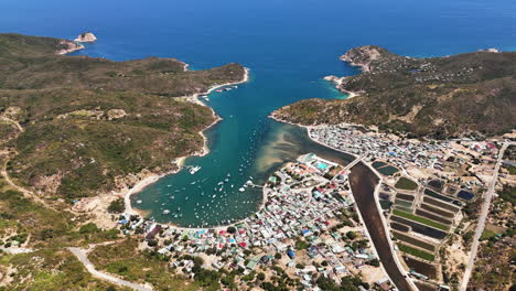 spectacular aerial establishing shot of vinh hy bay, vietnam surrounded by nui chua national park