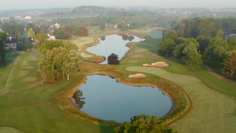 country club private golf course and water hazards among sand sand bunkers