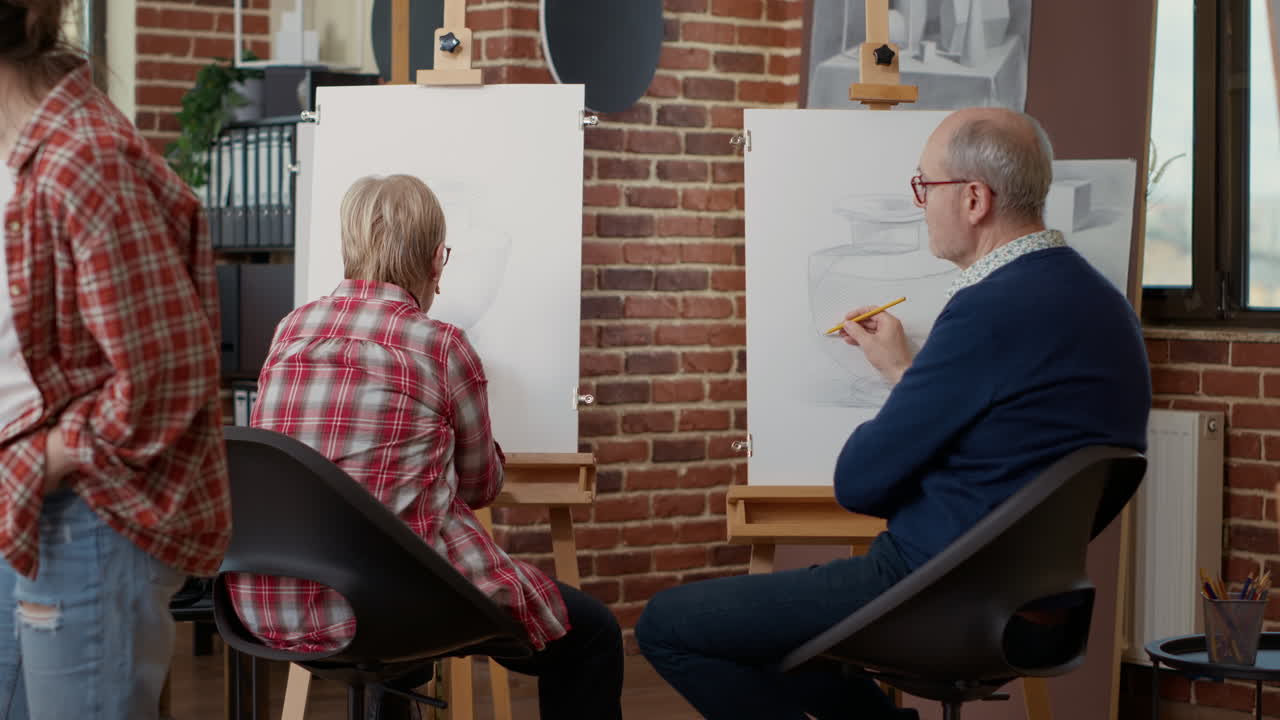Elder people learning to draw on canvas in art workshop