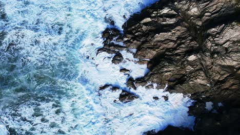 Atlantic-Ocean-Waves-Crashing-in-Slow-Motion-Over-Slate-Rocks-Along-Cornish-Coastline