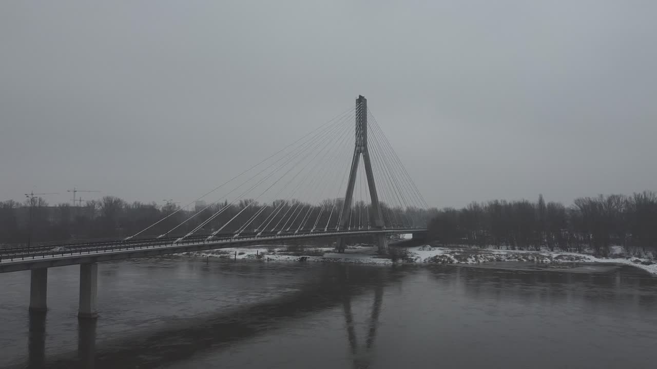Drone video of and swietokrzsyki bridge, warsaw  above Vistula river on a  snowy day -1