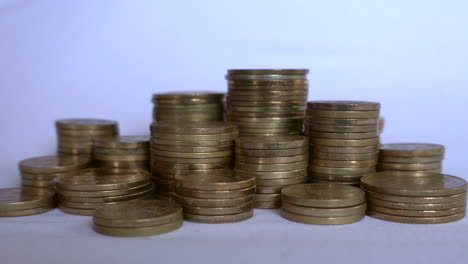 stacks of nepali coins on a white background