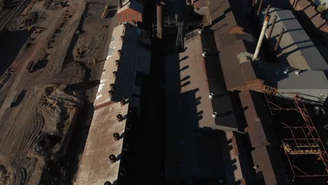 Eagle-eye-aerial-view-of-rusty-old-steel-mill-about-to-be-demolished