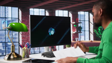 vertical video black freelancer at home watching business conference on pc monitor