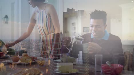 animation of happy diverse family having breakfast over cityscape