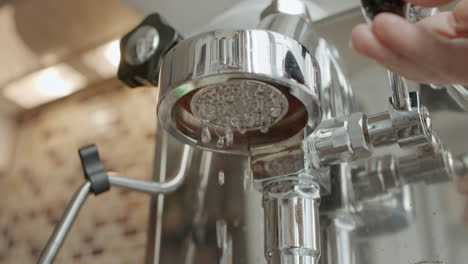 flushing water from portafilter mount of espresso coffee machine for pre rinse in slowmo