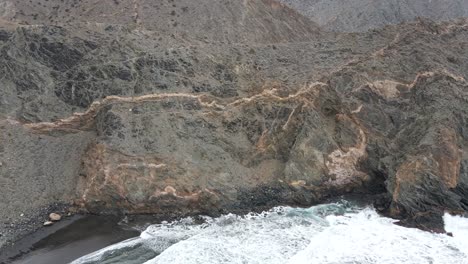 aerial view couple travelers, man and woman, hiking in rugged mountains in la gomera, canary islands