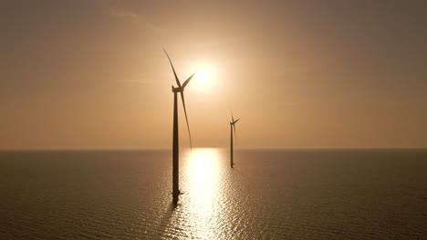 Windturbinensilhouette,-Die-Sich-über-Wasser-Dreht,-Windpark-Bei-Sonnenuntergang,-Luftrückzug