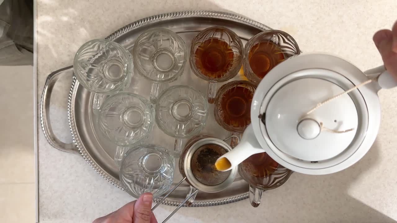 Turkish tea service in garden cafe with waiter delivering hot chai in glass cups on metal tray capturing essence of traditional Turkish hospitality vibrant outdoor dining in Iran local people home