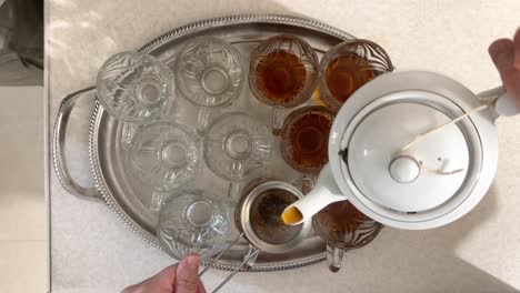 turkish tea service in garden cafe with waiter delivering hot chai in glass cups on metal tray capturing essence of traditional turkish hospitality vibrant outdoor dining in iran local people home