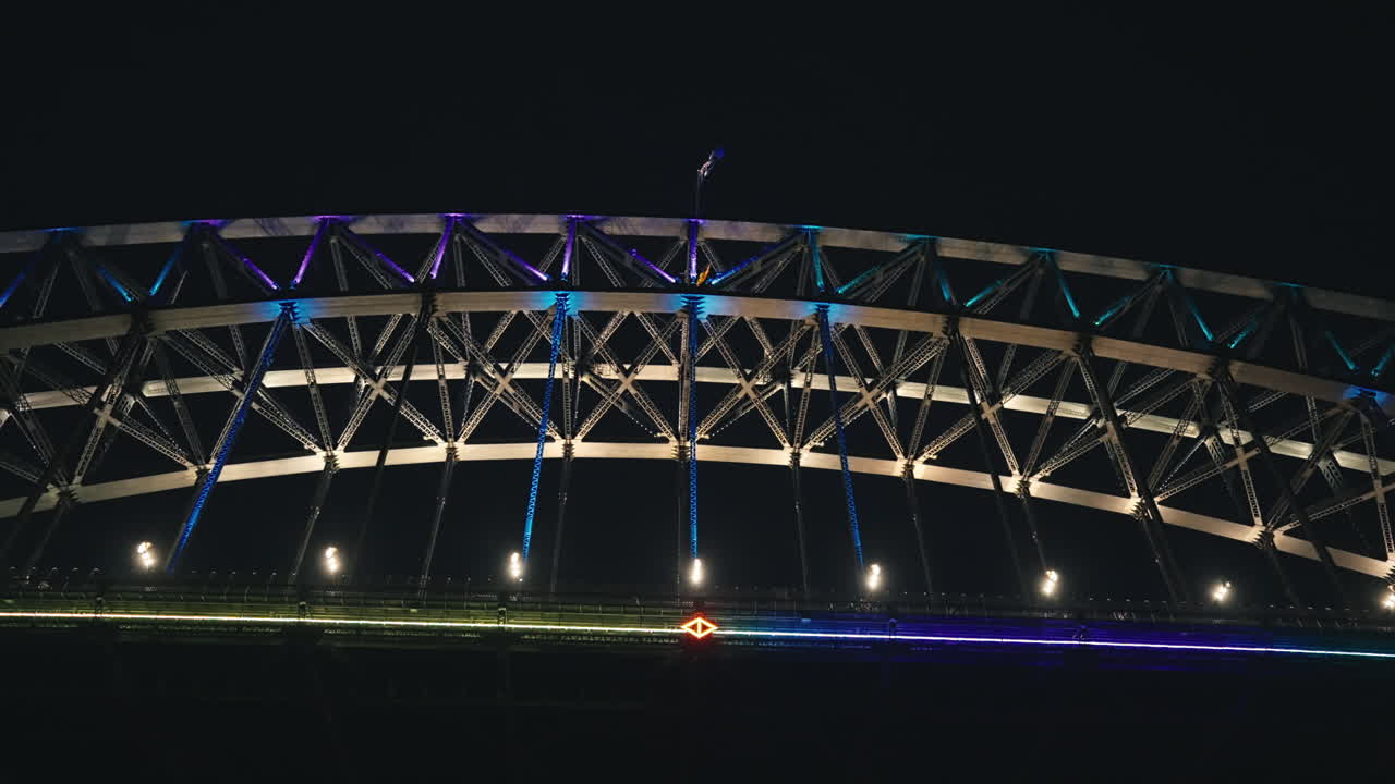 hermosas luces de colores parpadeantes en el puente del puerto de sydney desde abajo durante un festival vívido en cámara lenta